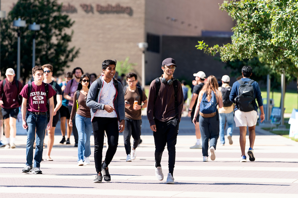 Students with backpacks walking through campus