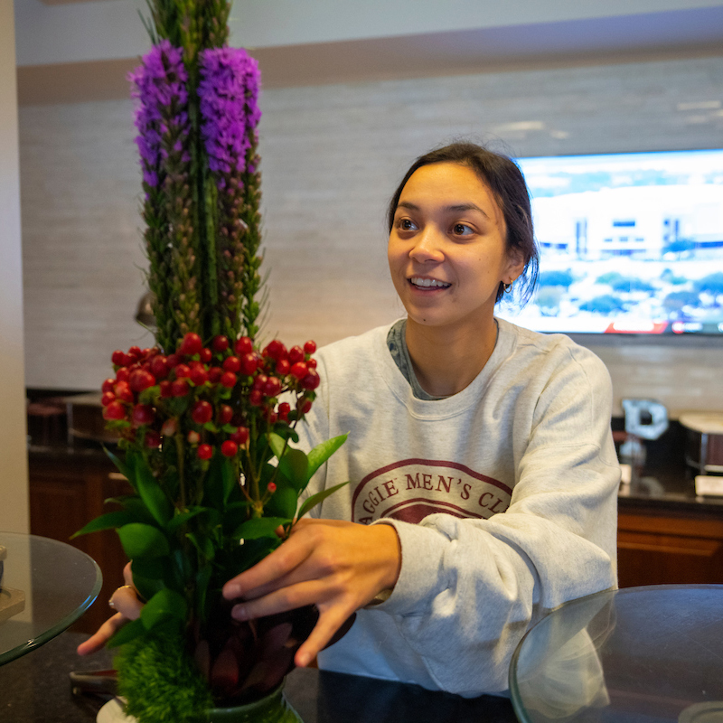 student sitting floral arrangement on a table