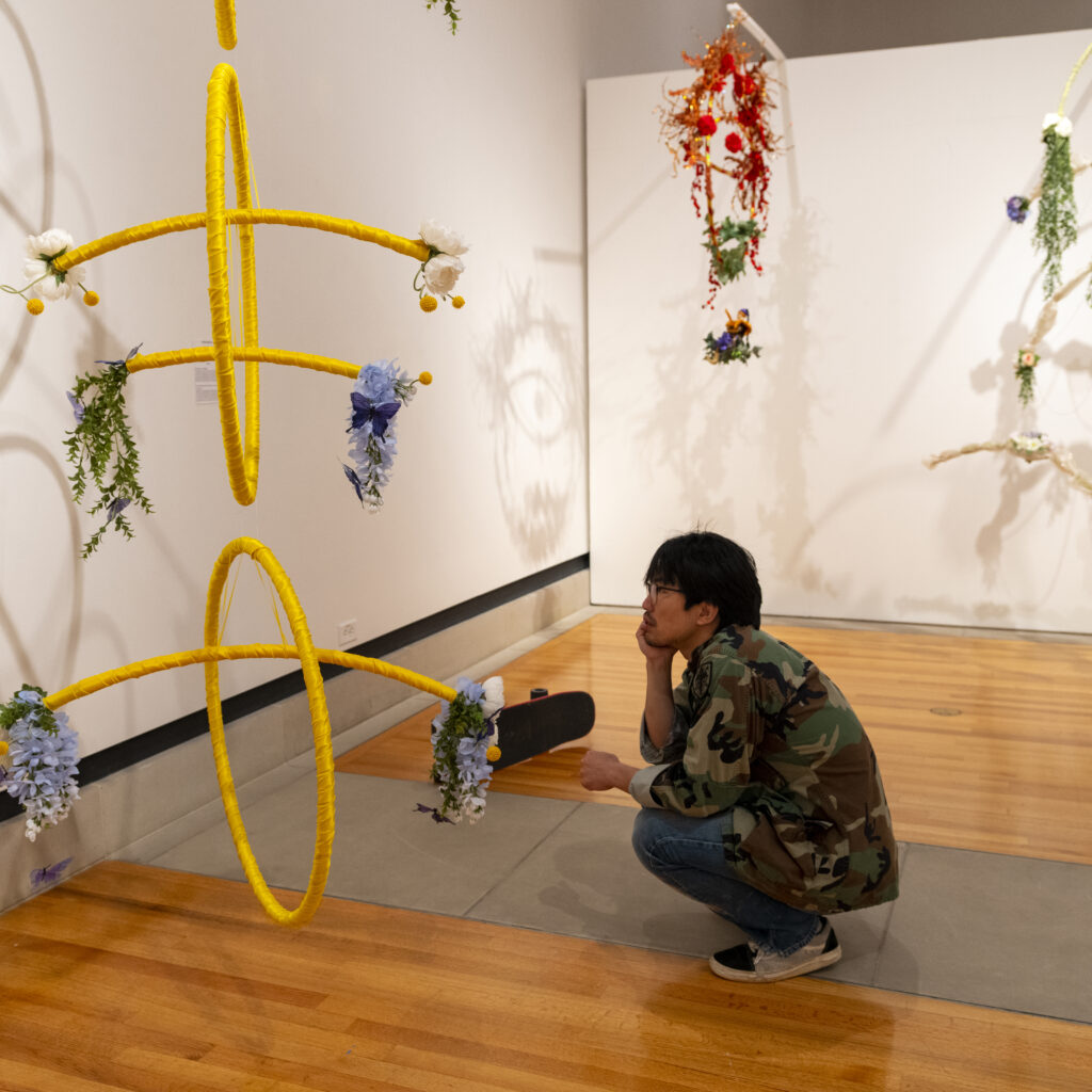 student studying a floral design exhibit