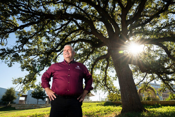 Michael Arnold standing in front of a large tree